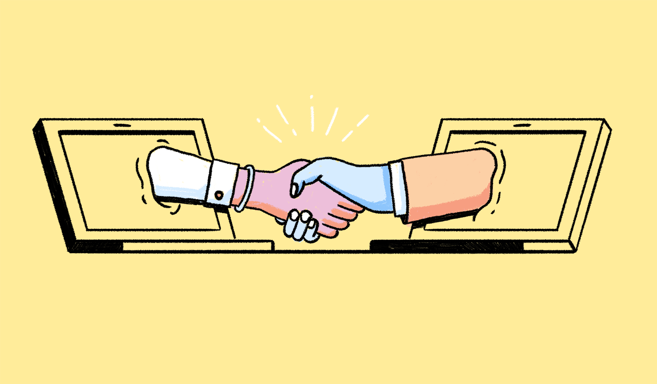 A handshake, with the respective arms reaching out from two different laptop monitors.