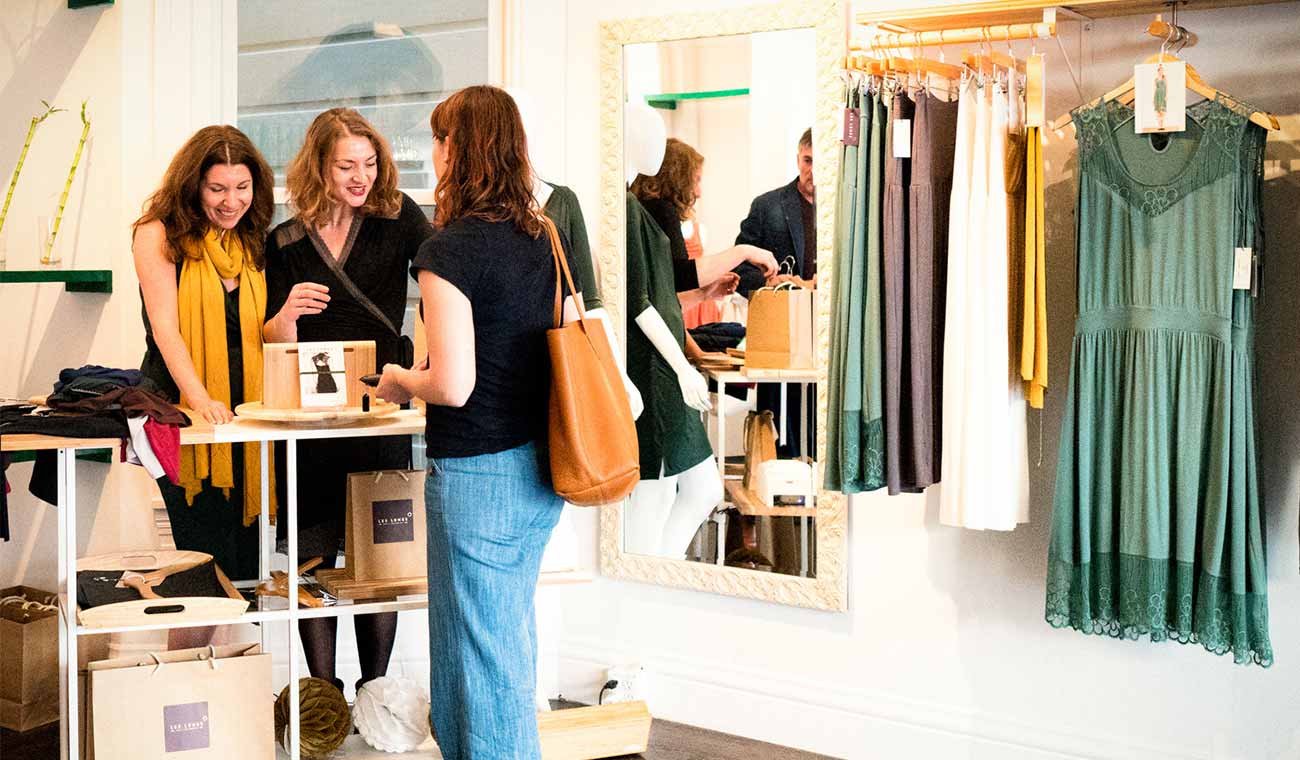 Photo of a shopper and employees at a Les Lunes store