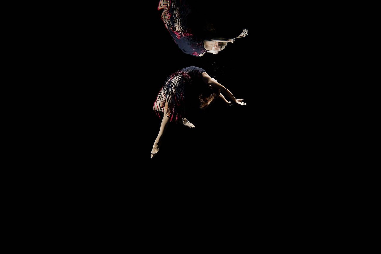 A photo of ballet dancers underwater