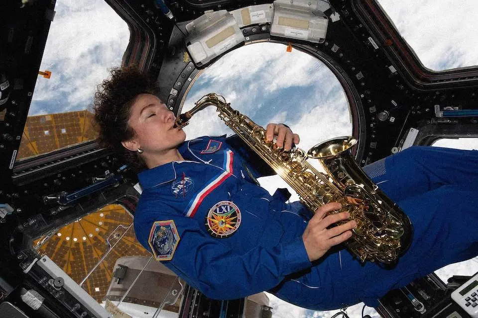 Photo of astronaut Jessica U. Meir playing sax in the Cupola. (credit: NASA)