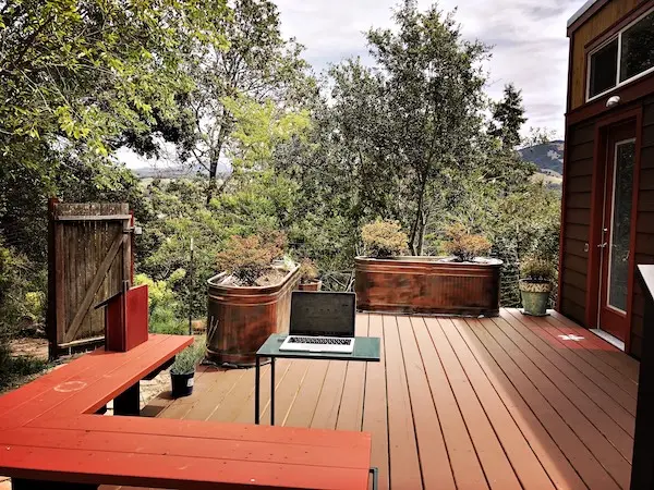 Tiny house deck workspace overlooking mountains