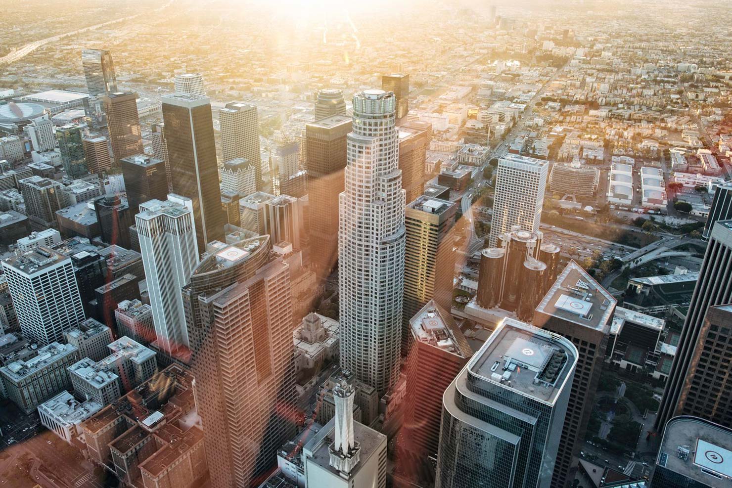 City scape with a sun flare washing over building tops