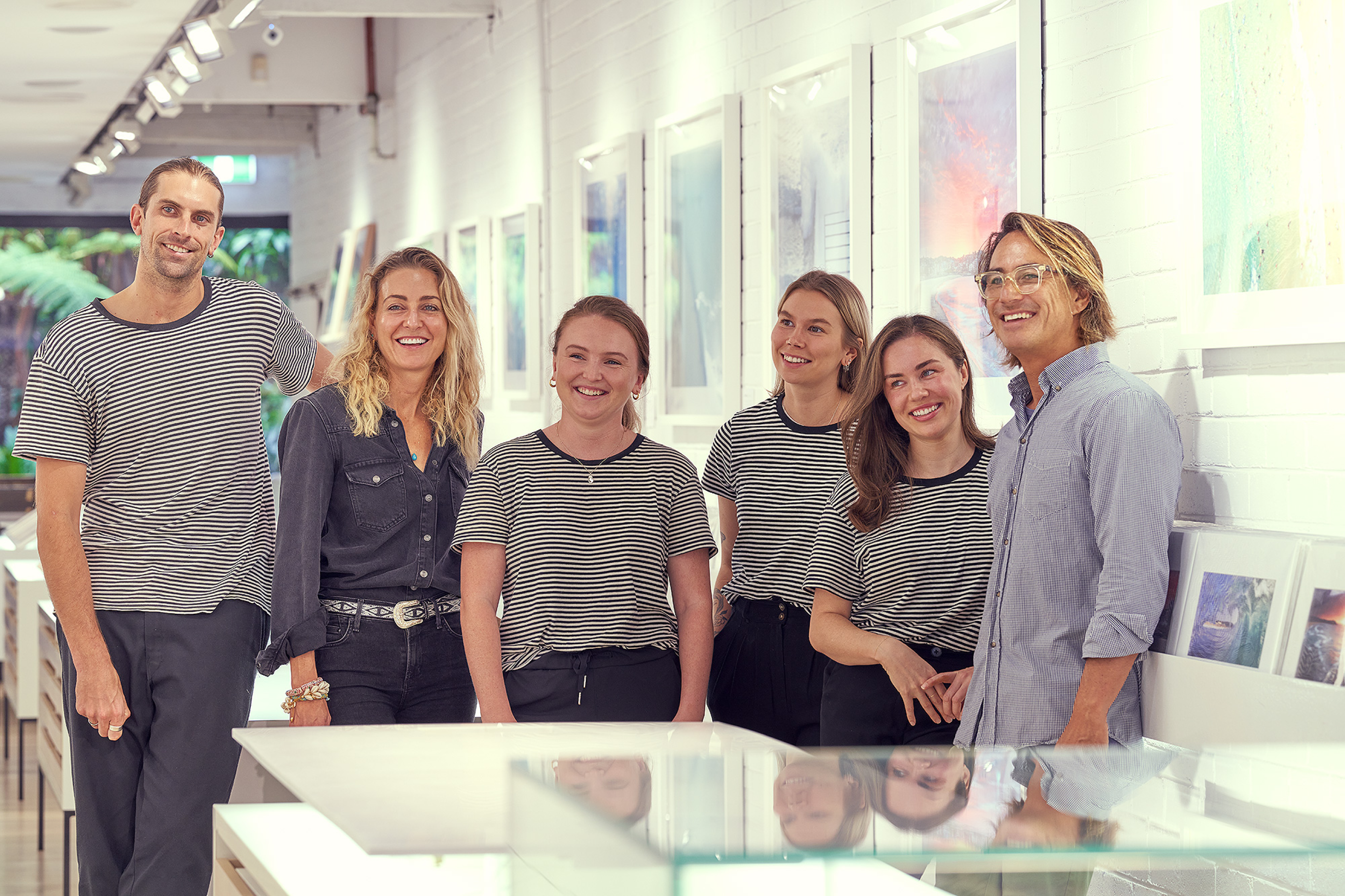 Six people on the Aquabumps team in the art gallery