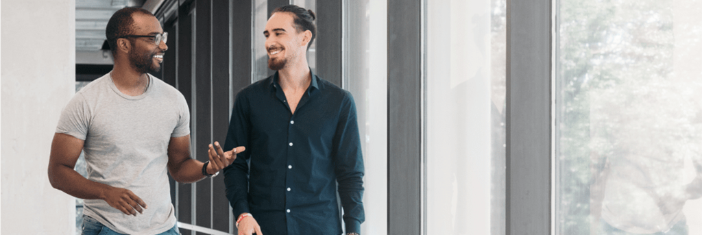 Two men walking in an office building