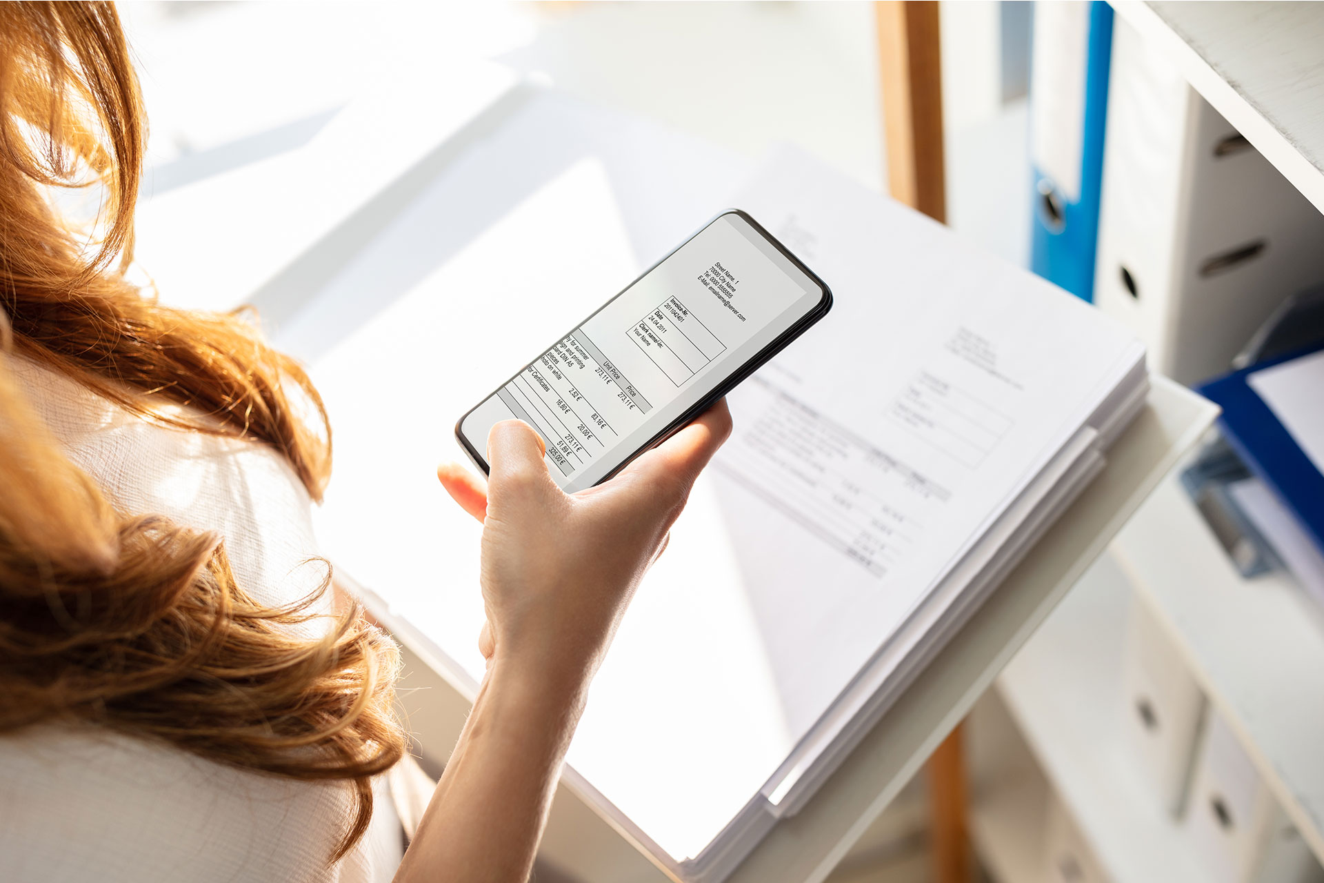 A person scanning an invoice with their phone