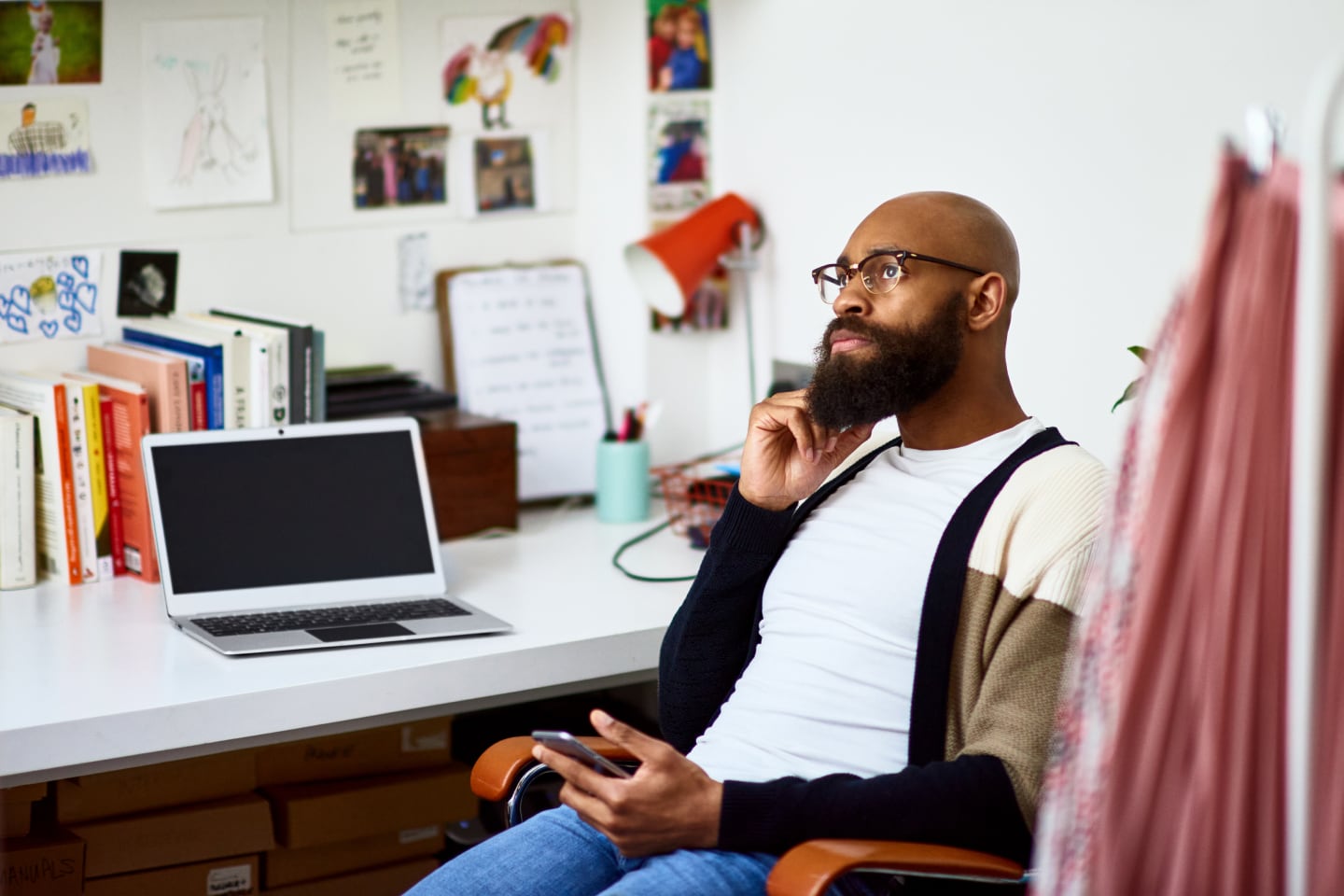 A professional sitting at a desk with a Windows computer on it.