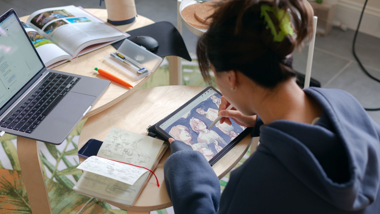 An artist drawing a piece of digital art on their iPad.
