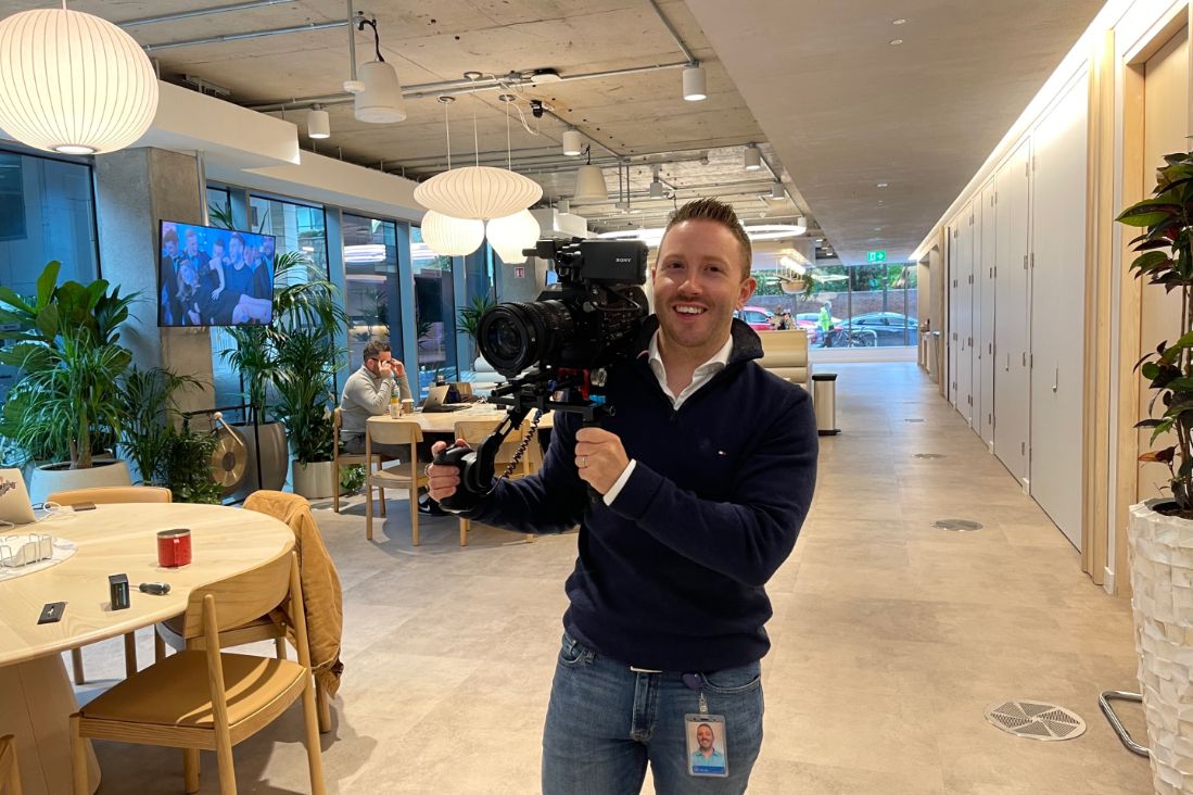 Man standing with a camera on his sholder