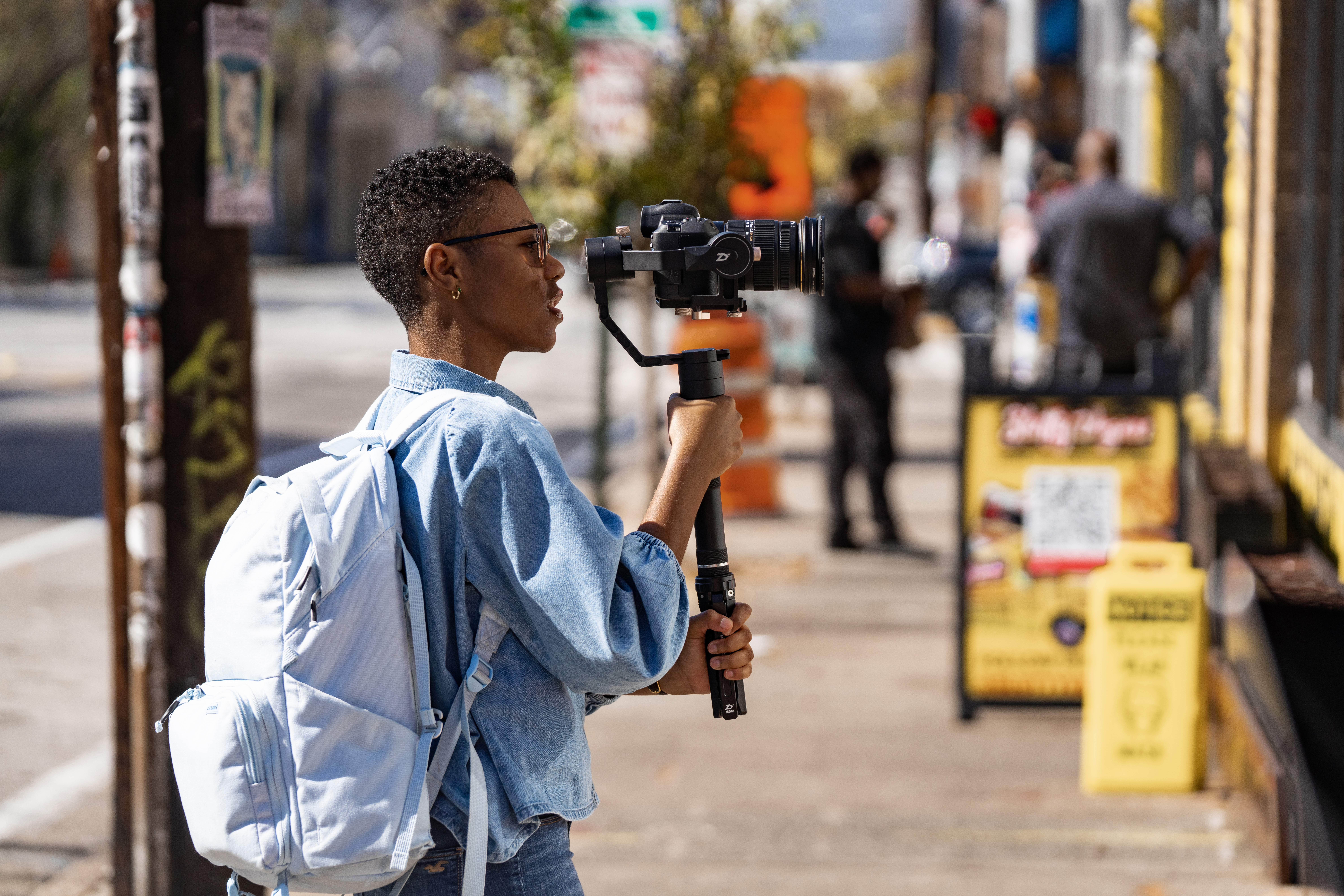 A videographer captures raw footage to send to the video editor