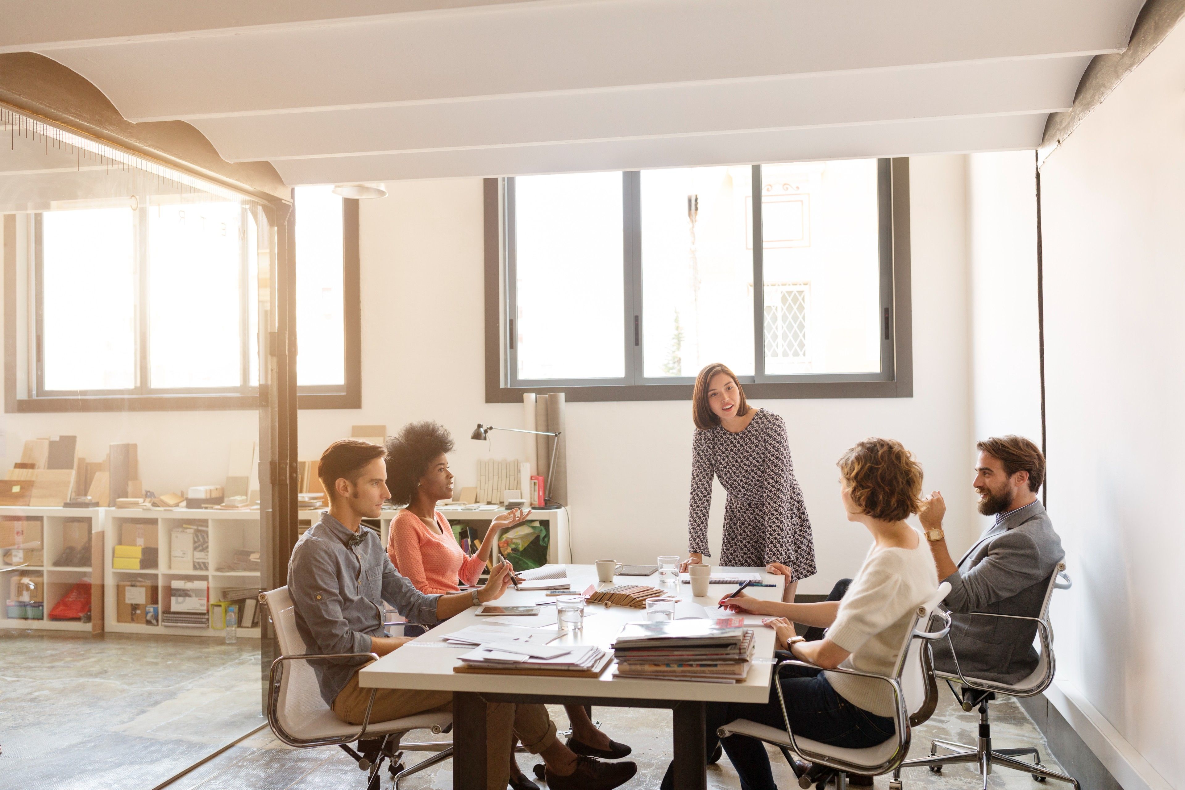 A group of people collaborating on a project at a conference table, which is essential during project planning.