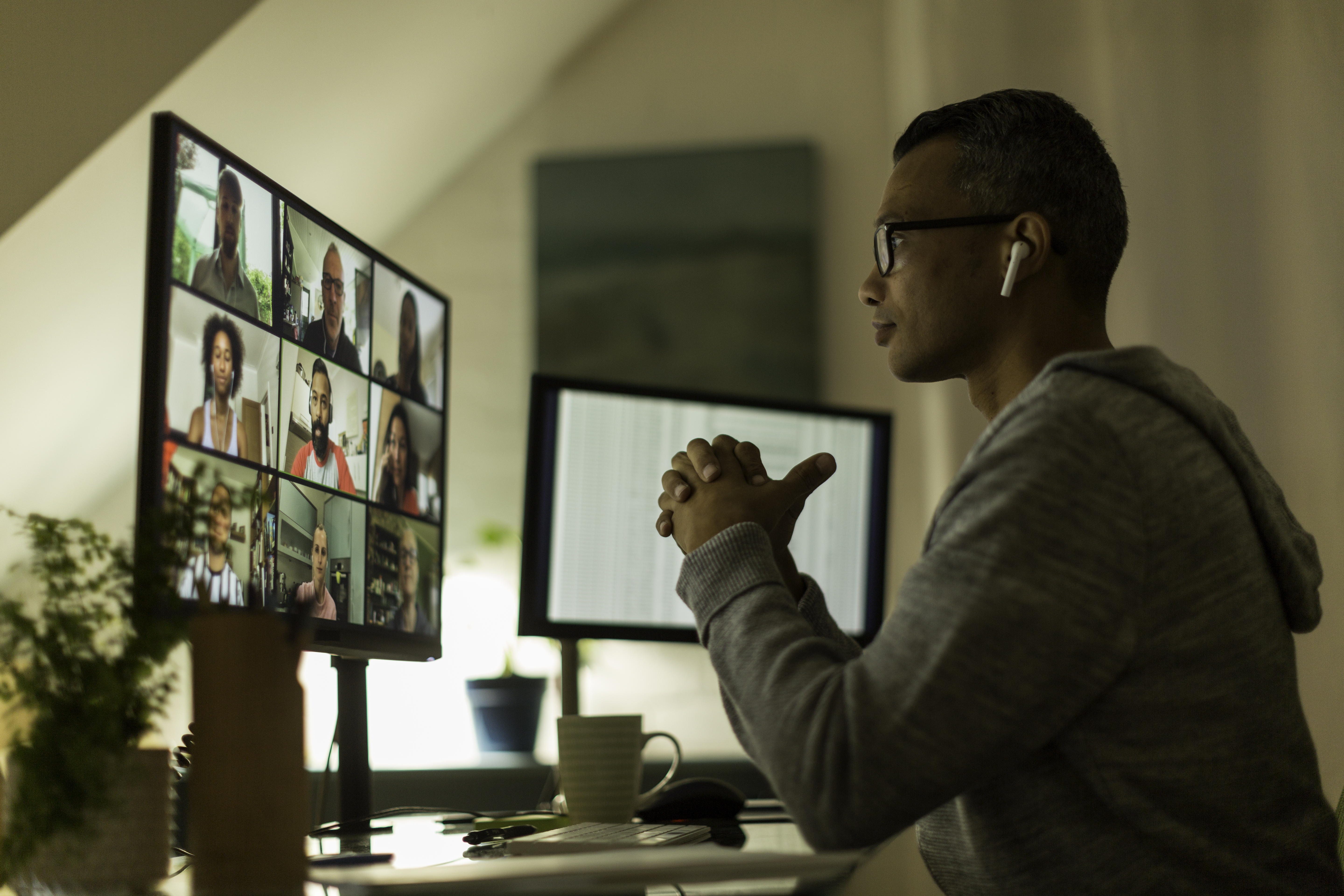 A remote worker looks at their computer monitor during a virtual meeting.