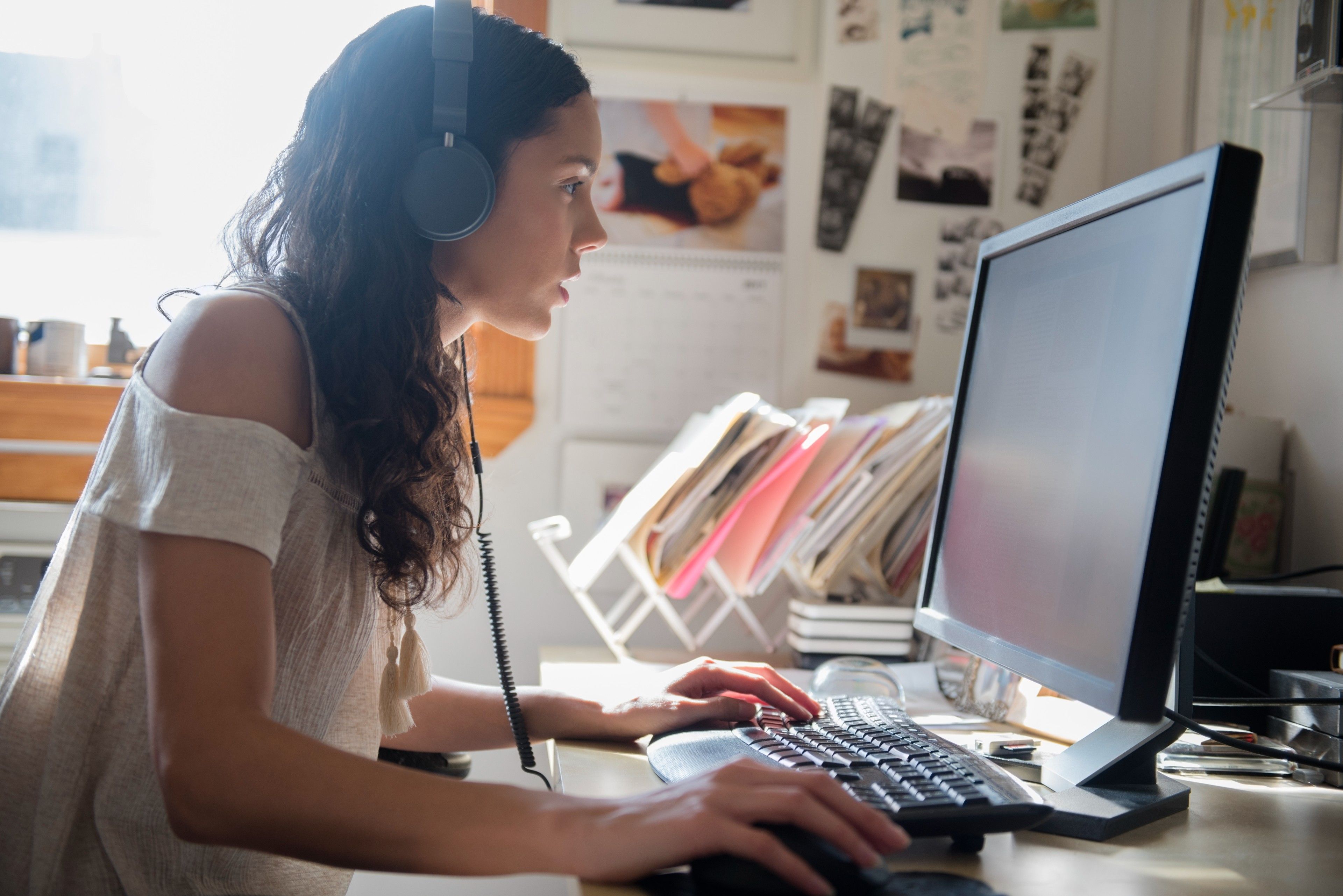 Un creativo con auriculares puestos trabaja en una computadora.