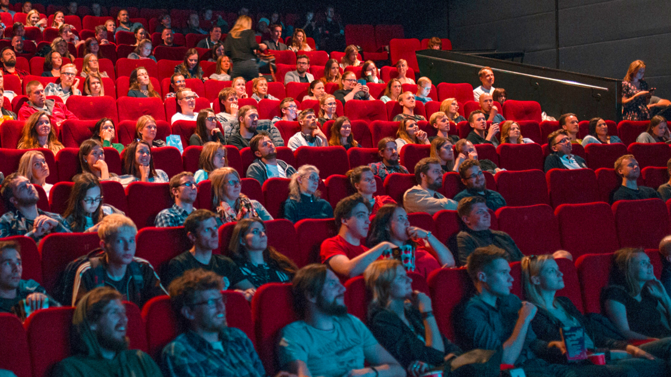 People sitting in a crowded movie theater