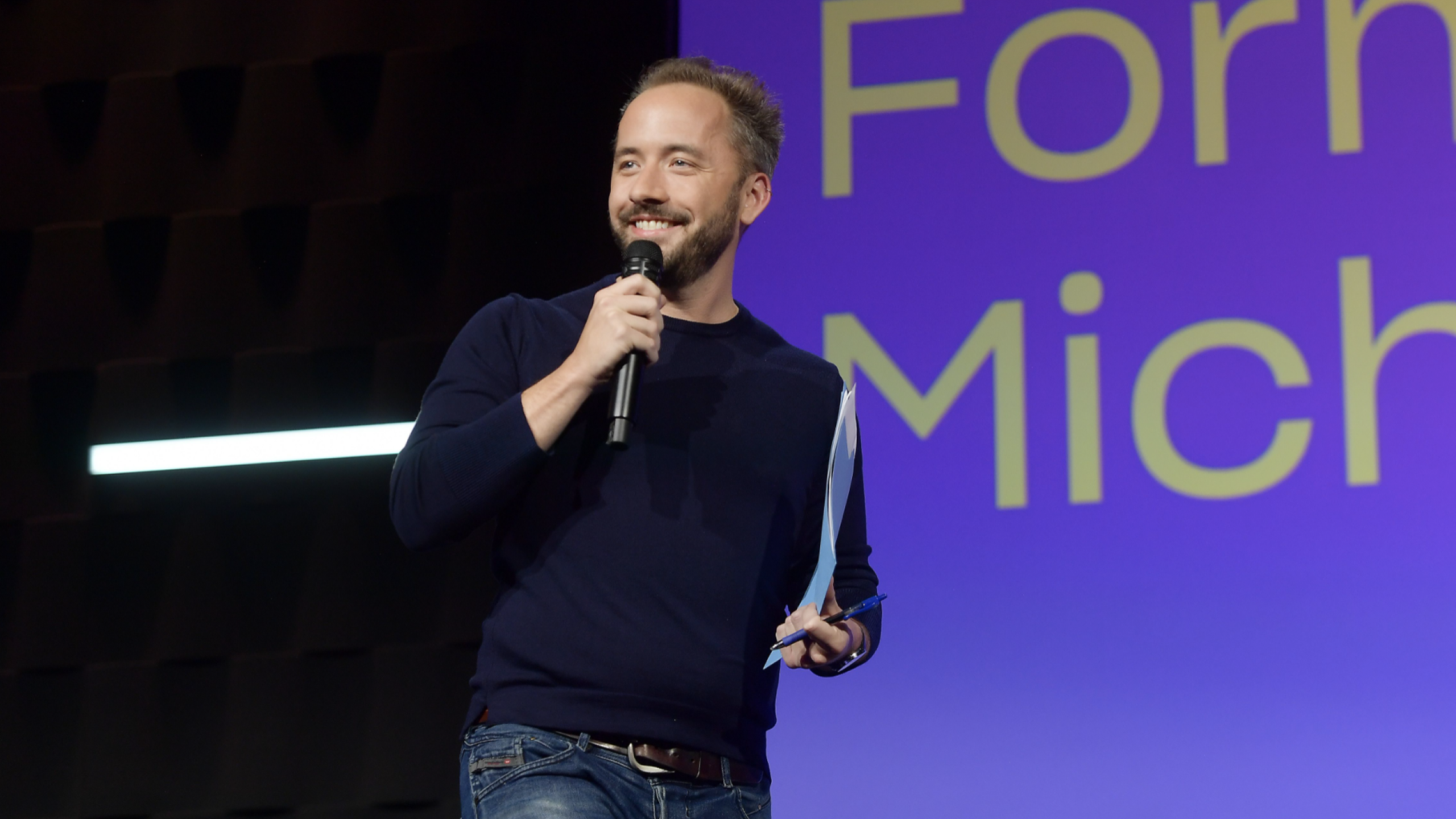 Drew Houston, Co-Founder and CEO of Dropbox, speaks with a microphone.