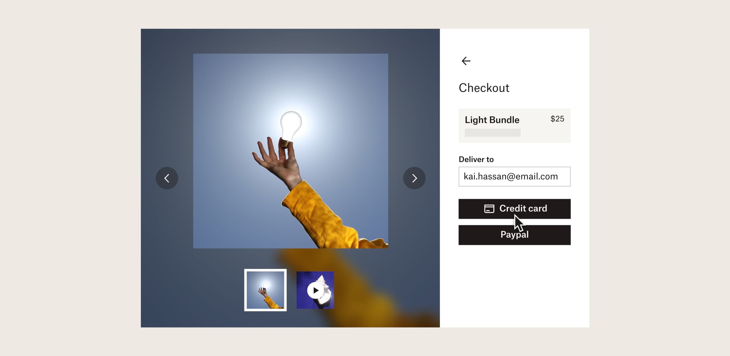A person buying art of a hand holding a light bulb by credit card in Dropbox Shop