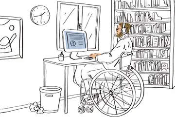 Person sits in a wheelchair working at a desk on their computer, beside them there is a large clock on the wall